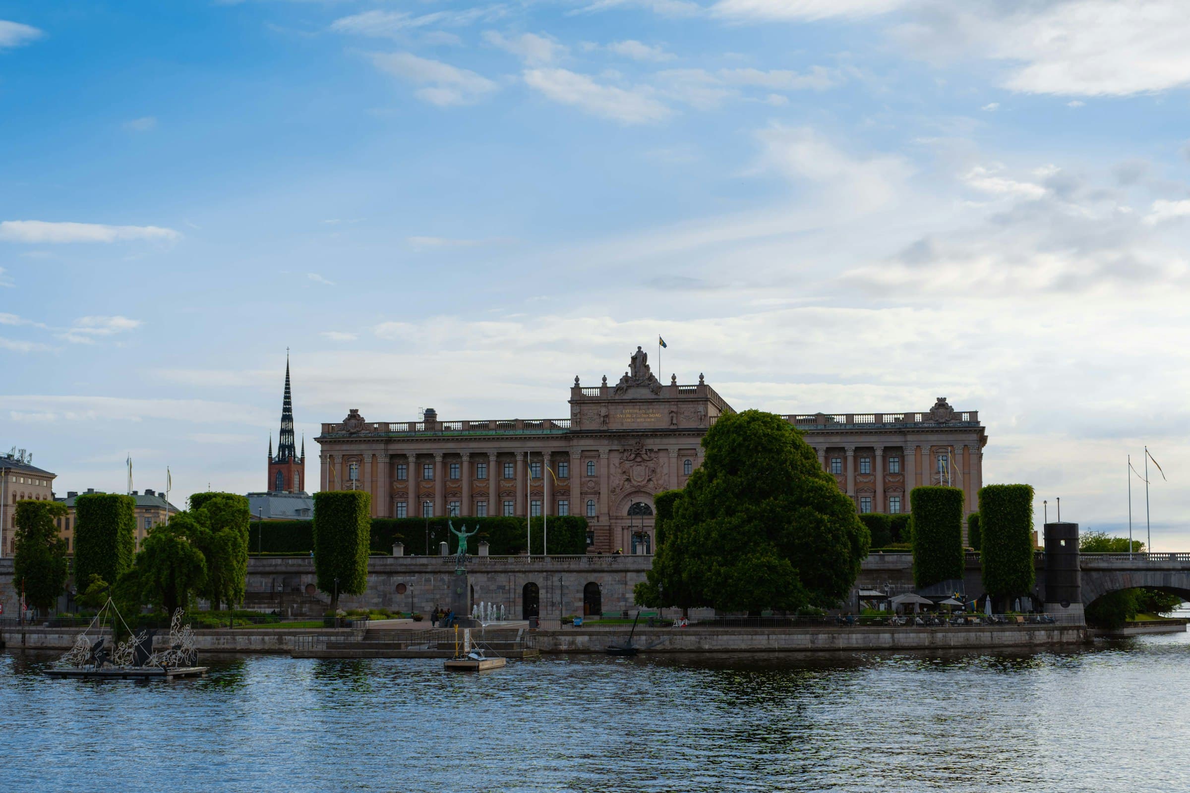 The Swedish Parliament House on Helgeandsholmen in Stockholm, seen across the water with the spires of Gamla Stan behind