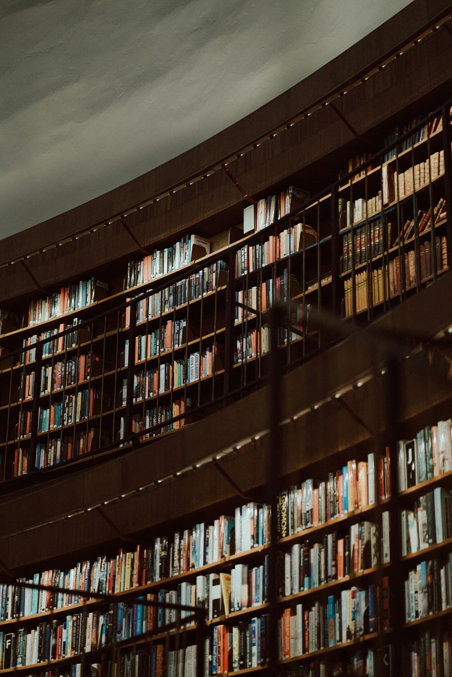 Curved rows of bookshelves in the Stockholm Public Library, reaching up towards the rotunda ceiling